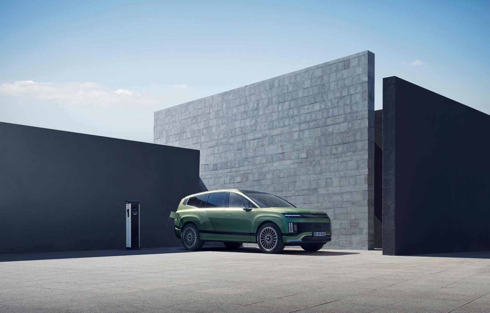 Hyundai IONIQ 9 у зарядной станции, вид спереди в три четверти
